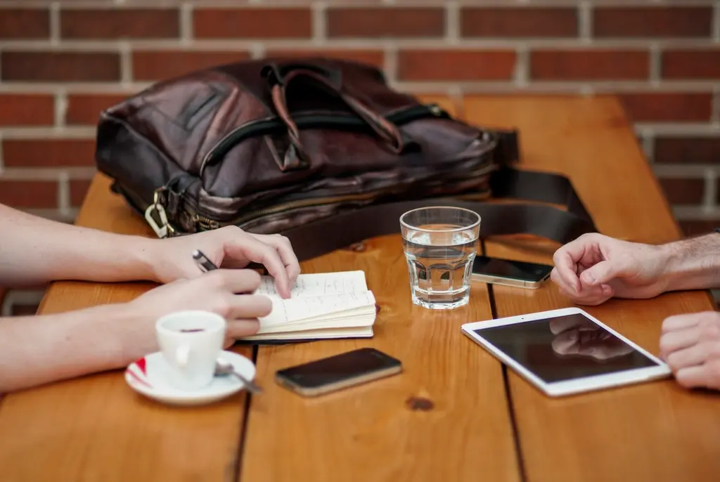 Two professionals in a business meeting reviewing a digital strategy presentation