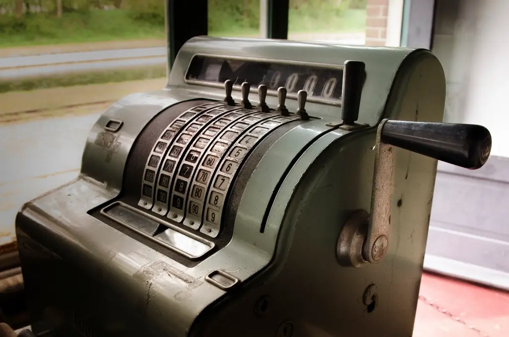Vintage cash register representing point-of-sale transaction systems