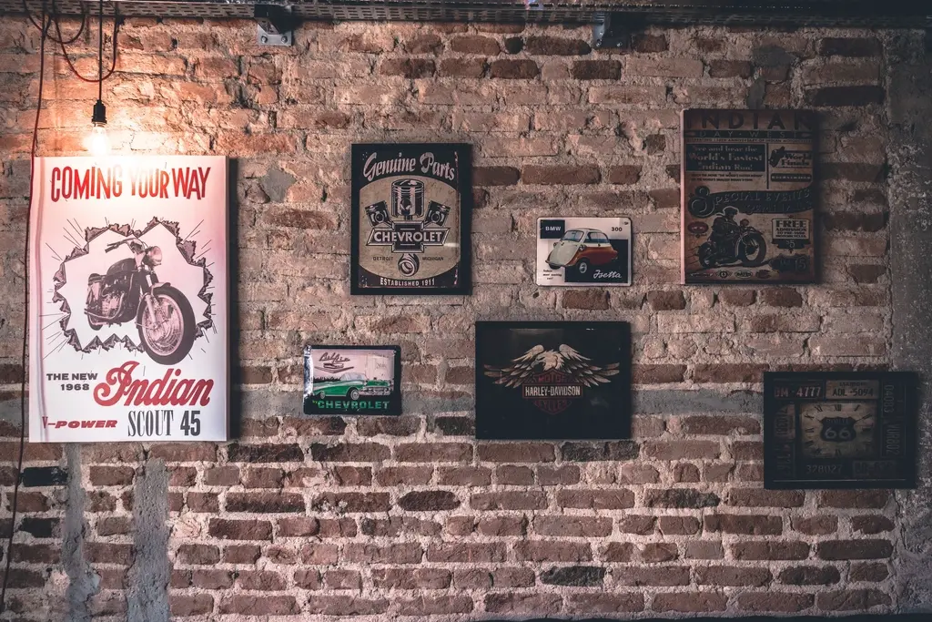 Posters displayed against a brick wall, representing print marketing materials