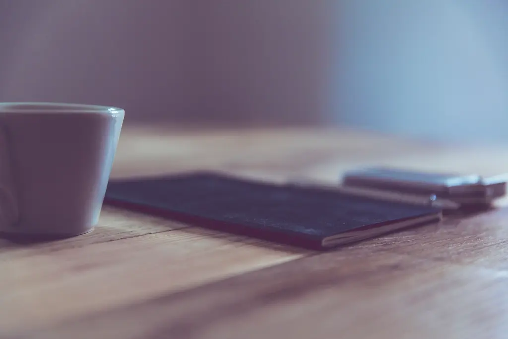 Notebook and phone on a table, representing SEO planning and strategy work