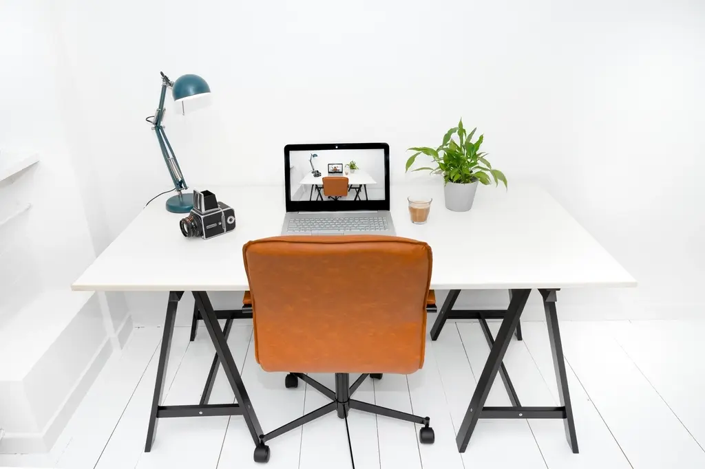 Modern office desk with a computer displaying a business dashboard, representing CRM portal development in Dubai