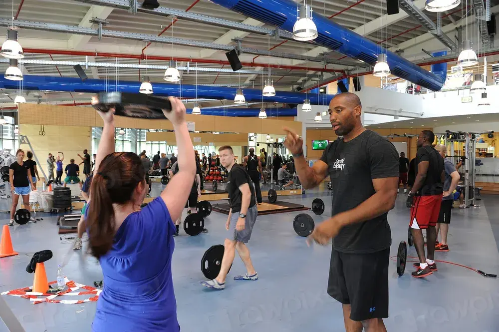 Person training with kettlebells in a gym, representing gym and fitness studio branding in Dubai