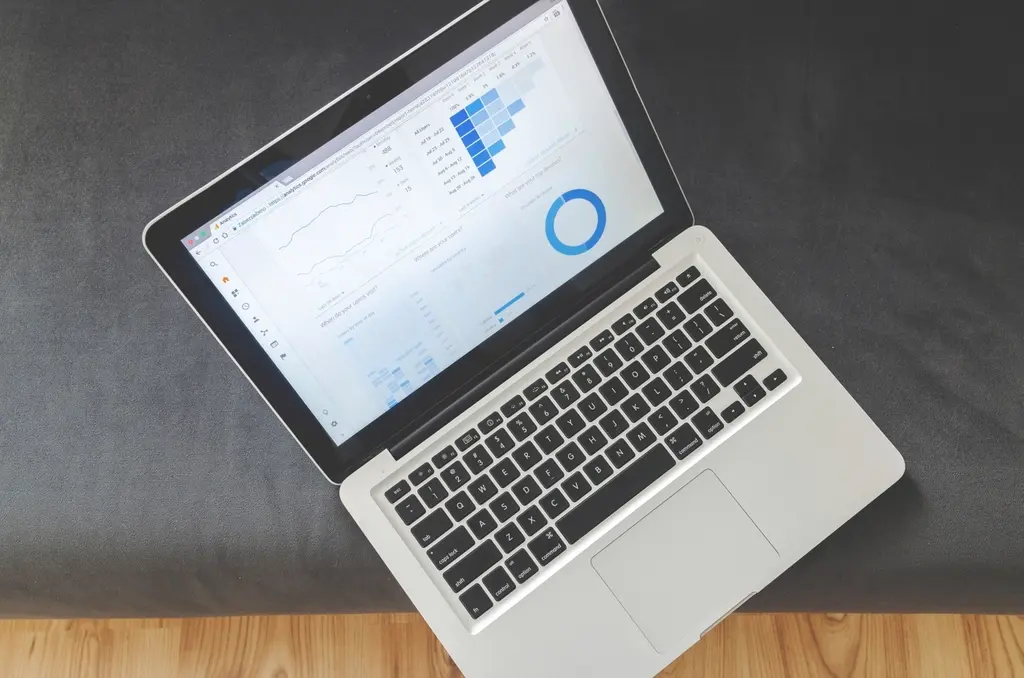 MacBook laptop displaying analytics charts and performance data