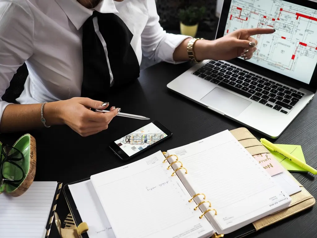 Business professional reviewing brand plans and materials on a laptop