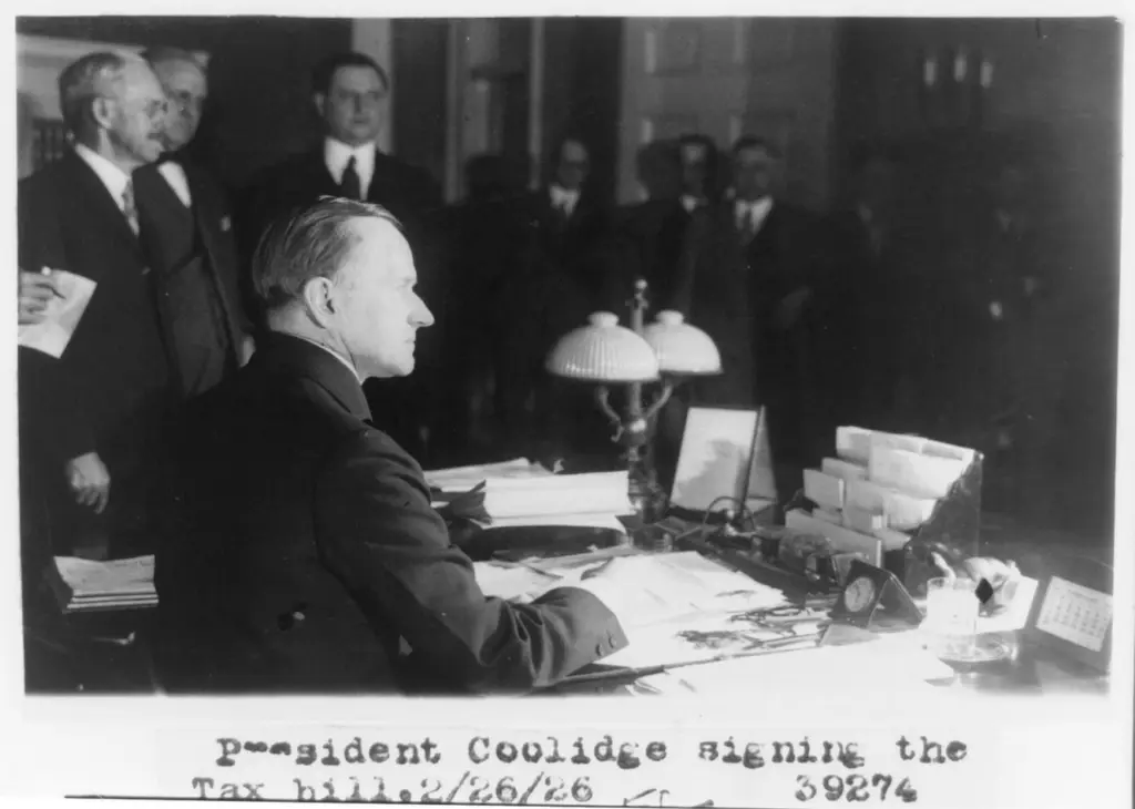 Business professional signing a document during a purchase decision meeting