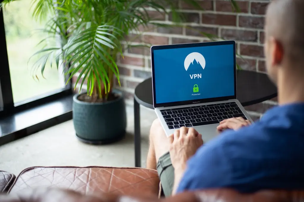Business professional using a laptop to access a secure client portal dashboard