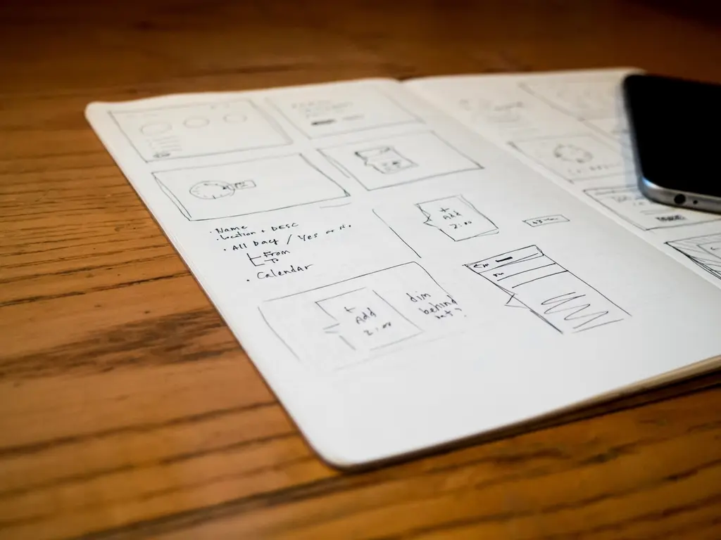 Hand-drawn wireframe sketch of a mobile app on an iPhone