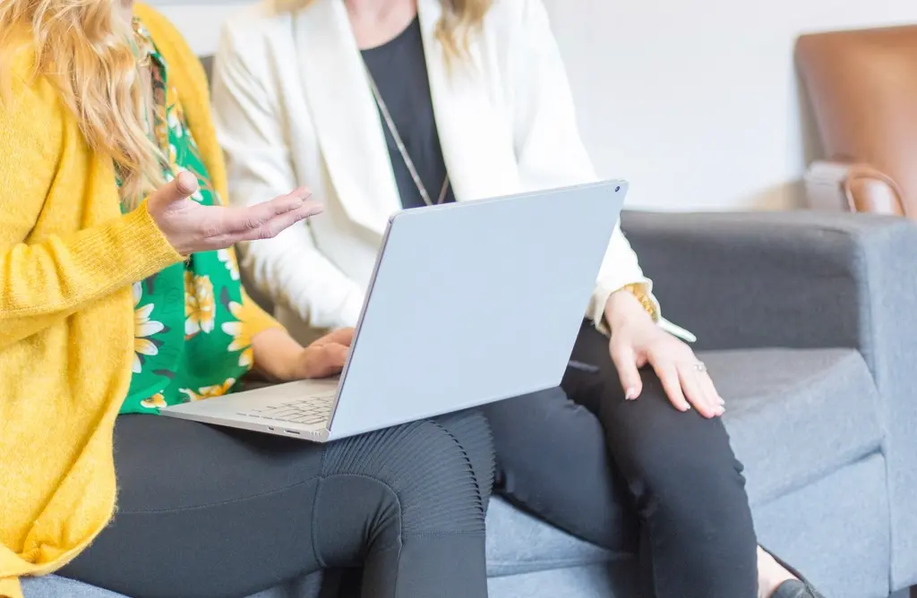 Woman working on a laptop, reviewing figures and project costs