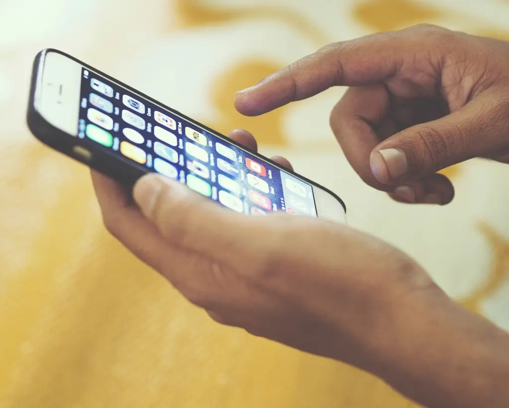 Hand swiping on a smartphone screen, representing digital contact sharing