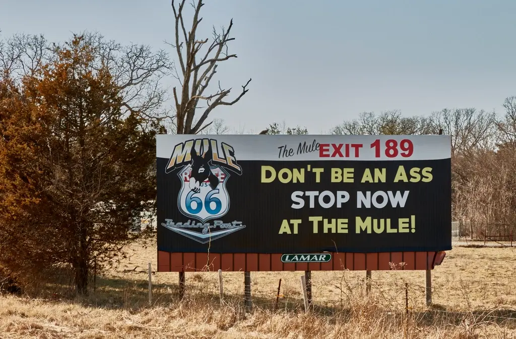 Outdoor advertising signage displayed in a public urban setting