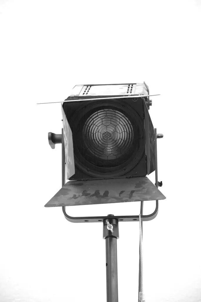 Professional camera lens and spotlight equipment in a studio setting