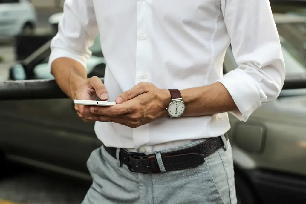 Person sending a text message on a mobile phone