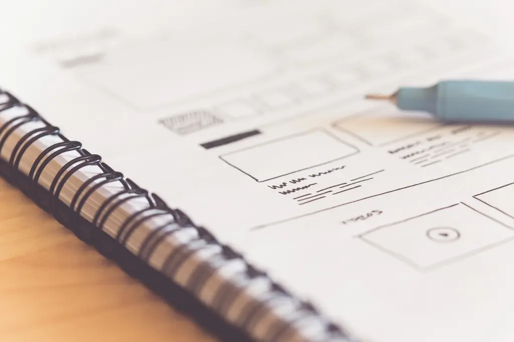 Sketched web design ideas and layout concepts on paper