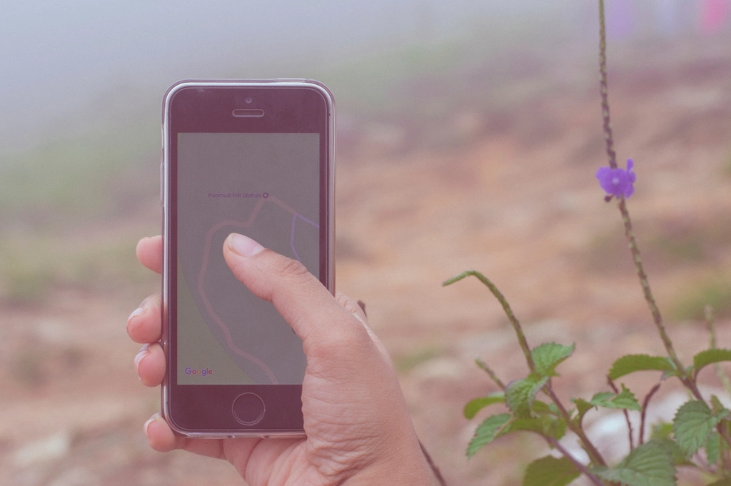 Hand holding a smartphone with a map app open, representing local SEO for Dubai businesses